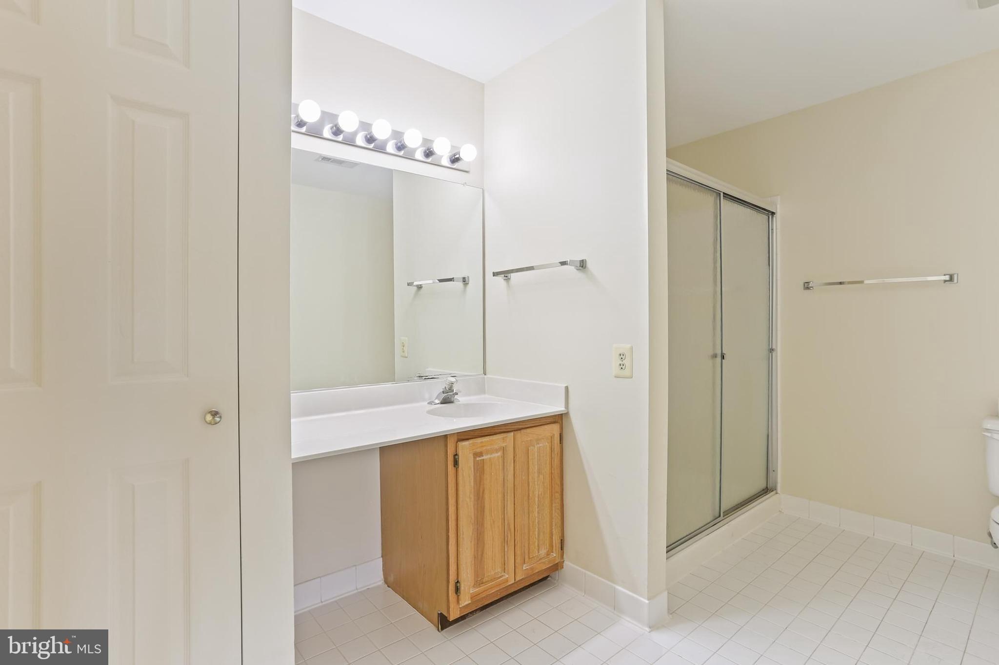 3907 Hannon Court, Unit 2A Baltimore, MD 21236 - Photo 19 of 34 a bathroom with a double vanity sink and a mirror