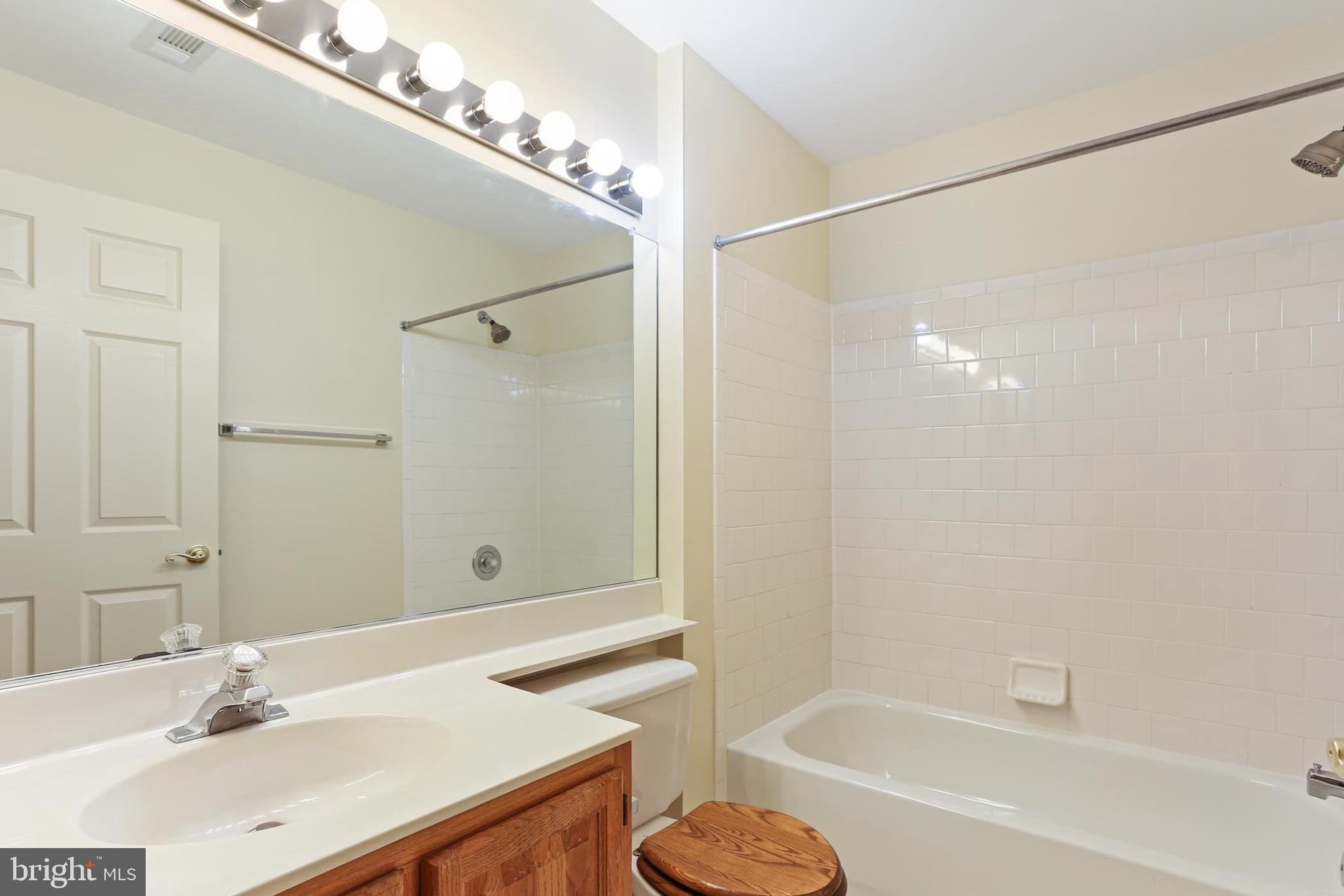 3907 Hannon Court, Unit 2A Baltimore, MD 21236 - Photo 26 of 34 a bathroom with a sink mirror toilet and bathtub