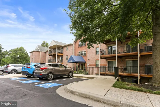 a view of a sign in front of a house with a big yard