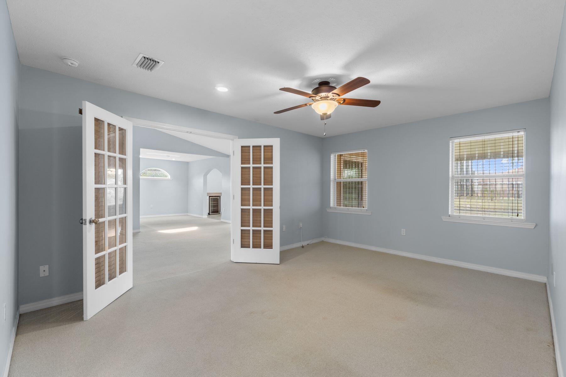 120 Hibiscus Lane Miramar Beach, FL 32550 - Photo 21 of 57 an empty room with chandelier fan and windows