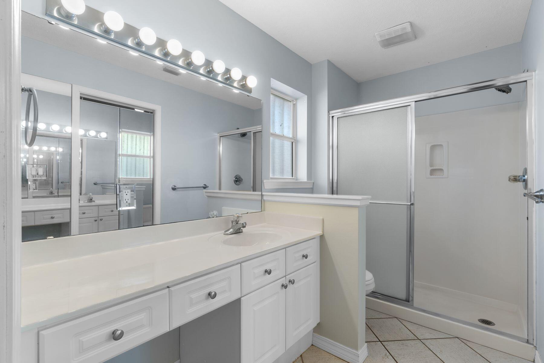 120 Hibiscus Lane Miramar Beach, FL 32550 - Photo 23 of 57 a bathroom with a double vanity sink mirror and shower