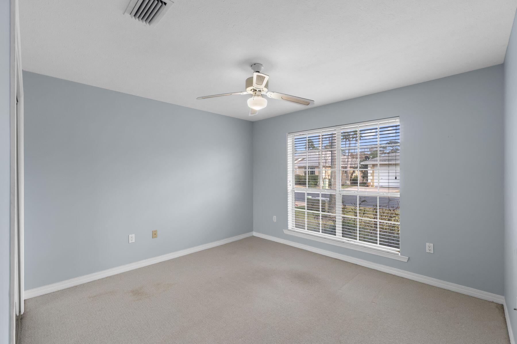 120 Hibiscus Lane Miramar Beach, FL 32550 - Photo 27 of 57 an empty room with chandelier fan and windows