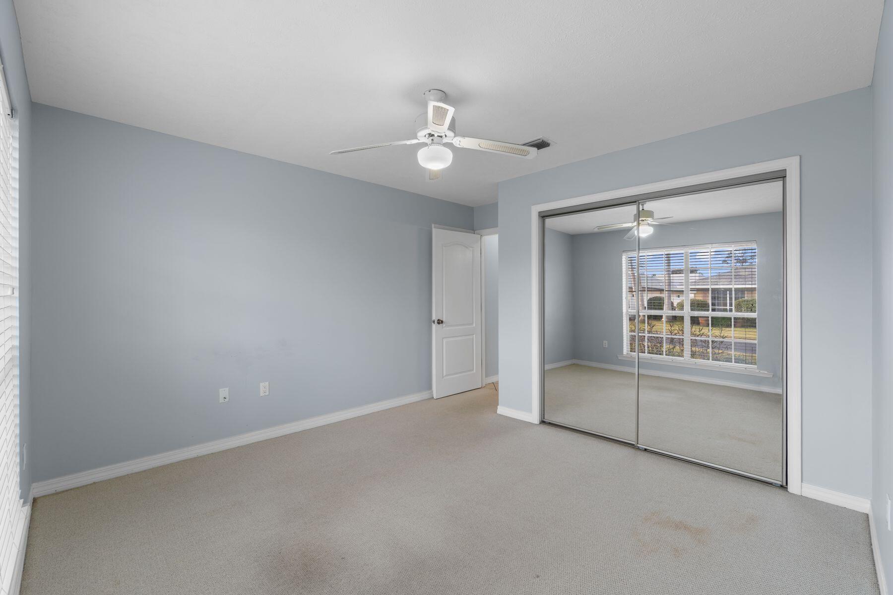 120 Hibiscus Lane Miramar Beach, FL 32550 - Photo 28 of 57 an empty room with chandelier fan and windows