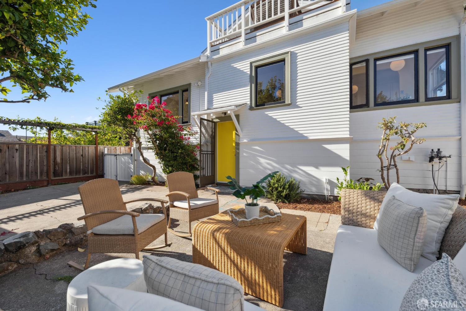 1968 Marin Avenue Berkeley, CA 94707 - Photo 69 of 75 a view of a patio with couches table and chairs with wooden fence