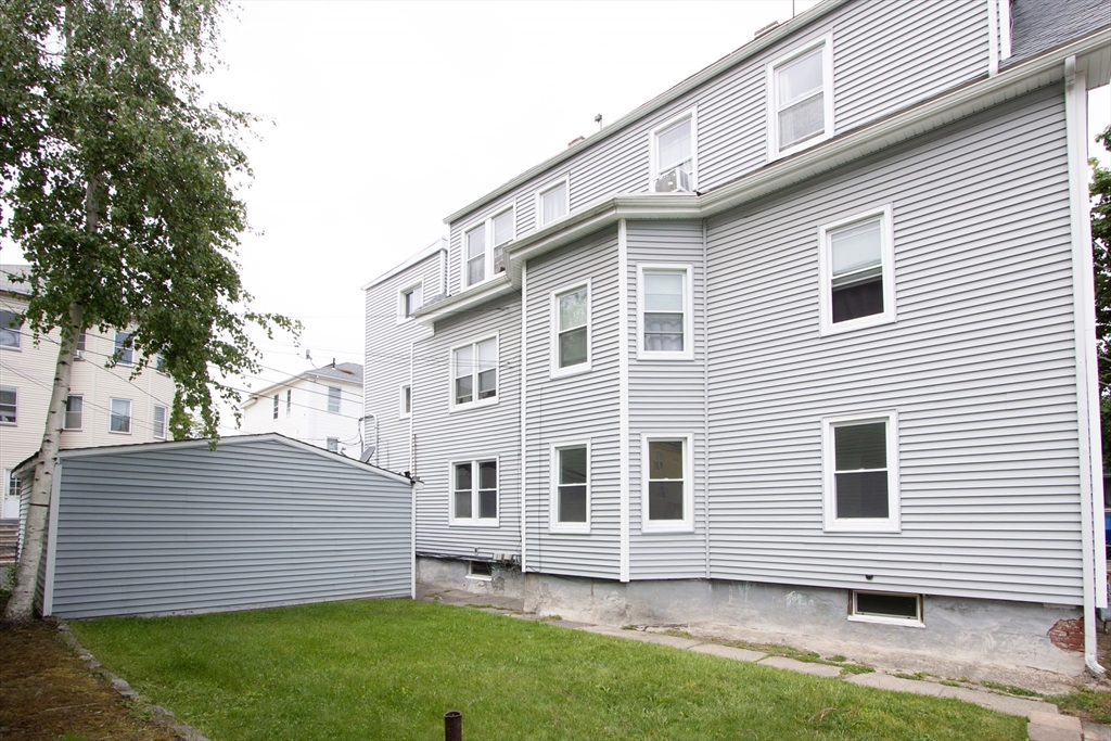 66 Cutler Street Worcester, MA 01604 - Photo 2 of 27 a view of a backyard with a garden