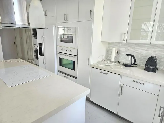 a kitchen with appliances a sink and cabinets