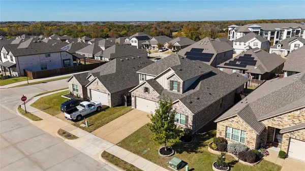 an aerial view of residential houses with outdoor space