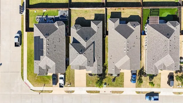 an aerial view of a house with parking space