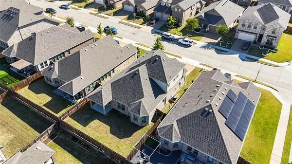 an aerial view of a building with beach and ocean view