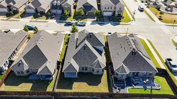 an aerial view of residential houses with outdoor space