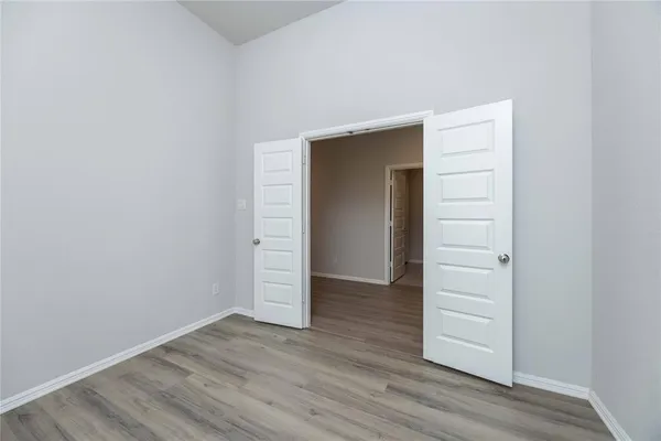 a view of wooden floor and entryway in a room
