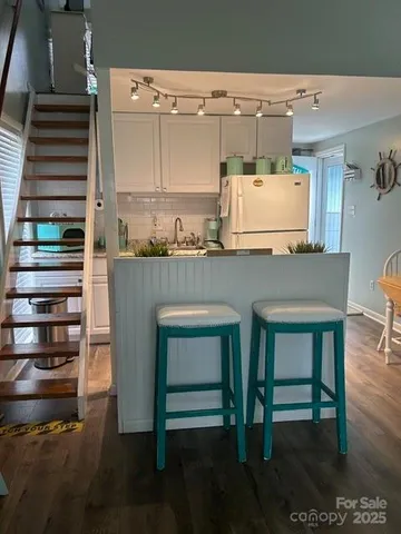 a kitchen with a table chairs and a refrigerator