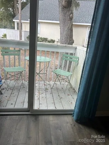 a view of balcony with wooden floor