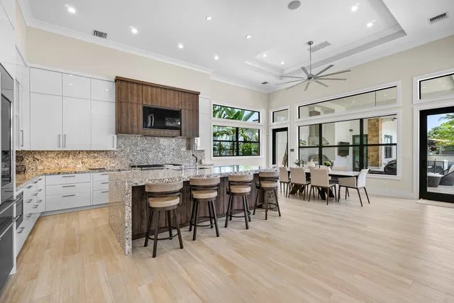 a kitchen with cabinets and chairs