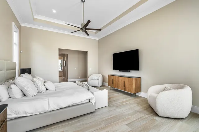 a view of a hallway with wooden floor and glass door