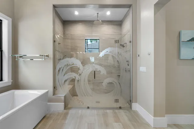 a bathroom with a glass shower door