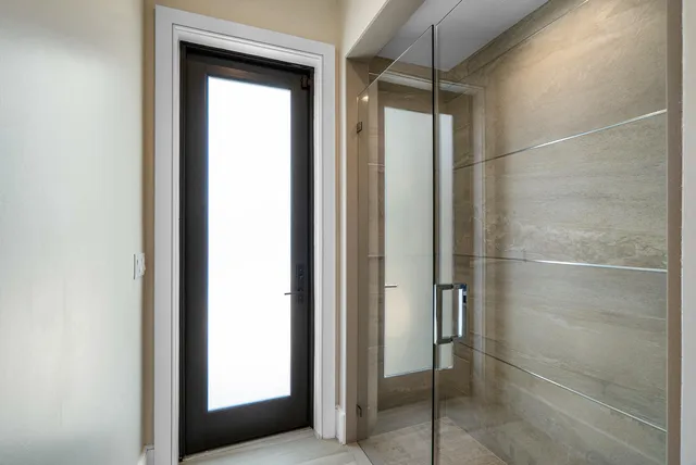a bathroom with a granite countertop sink a toilet and a mirror