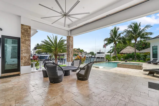 a view of swimming pool with outdoor seating and a garden