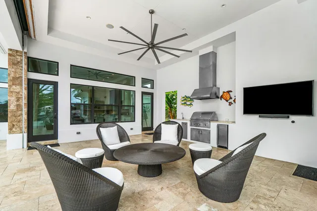 a view of a swimming pool and lounge chairs in patio