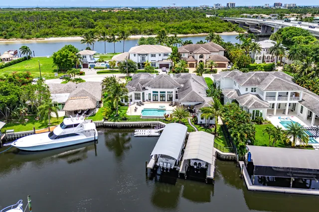 an aerial view of a house with a garden and lake view