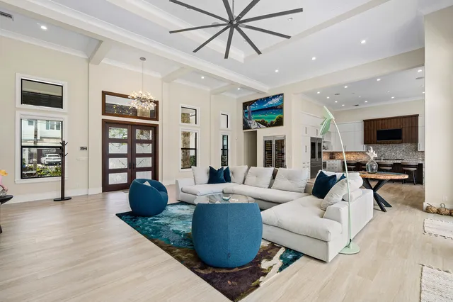 a living room with furniture wooden floor and ceiling fan