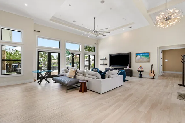 a living room with furniture a flat screen tv and a large window