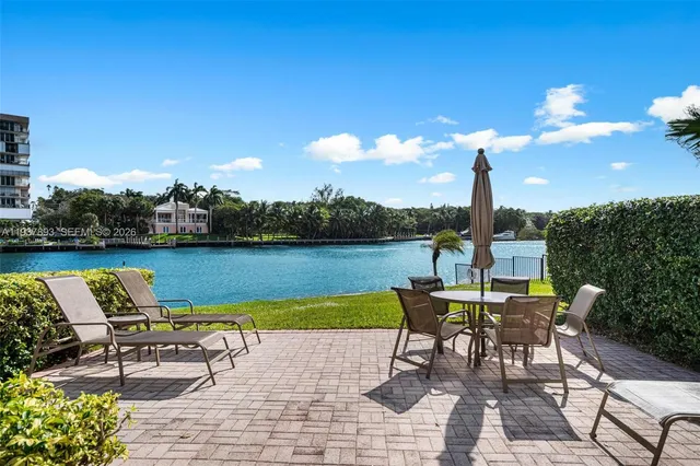 a view of a lake with table and chairs