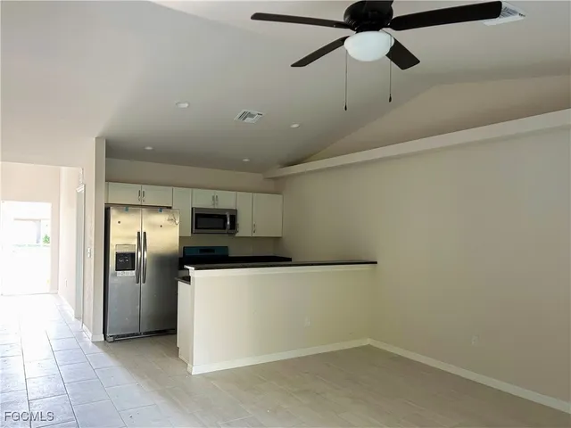 a kitchen with stainless steel appliances a refrigerator and a microwave