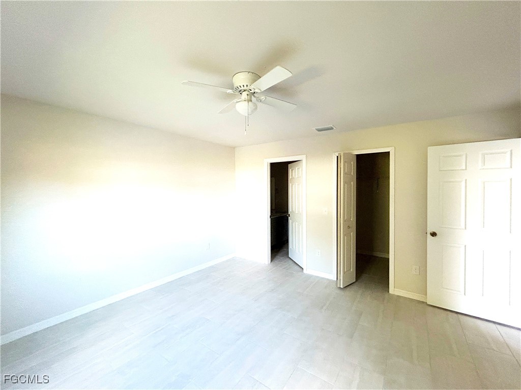 3608 Southwest 17th Avenue Cape Coral, FL 33914 - Photo 7 of 10 a view of an empty room with a ceiling fan