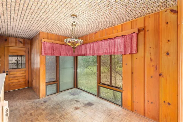 a view of a hallway with furniture and chandelier