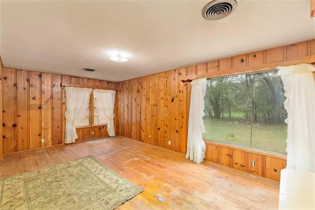 a view of a room with wooden floor and furniture