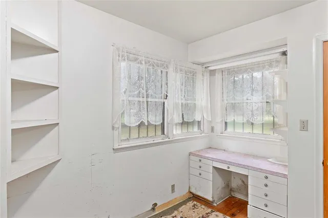 a bathroom with a sink mirror and a toilet