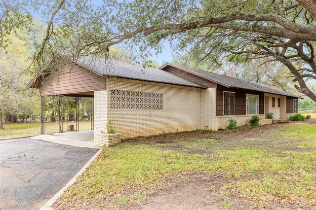 a backyard of a house with yard and outdoor seating