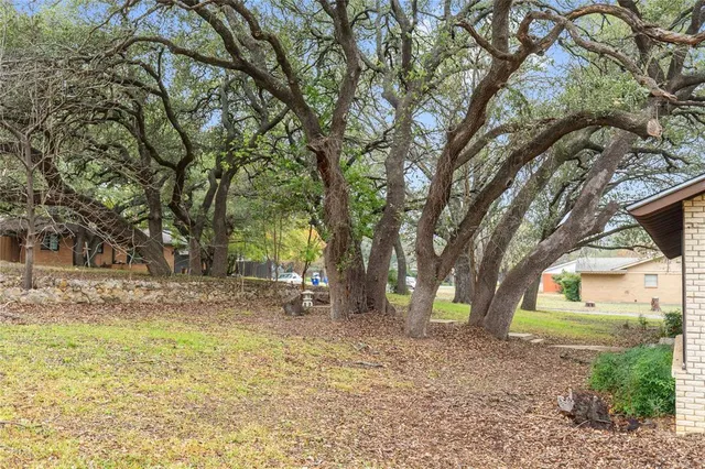 a pathway of a house with a yard