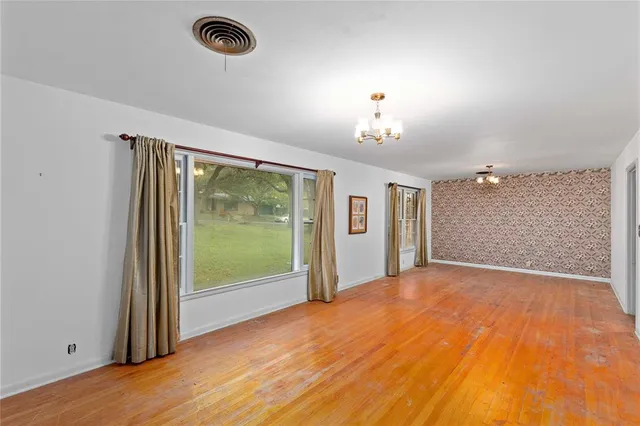 a view of a room with wooden floor and balcony