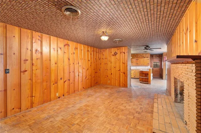 a view of a livingroom with an empty space and a window