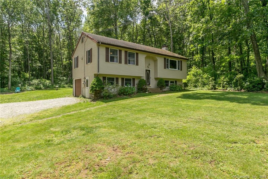 a front view of house with yard and green space