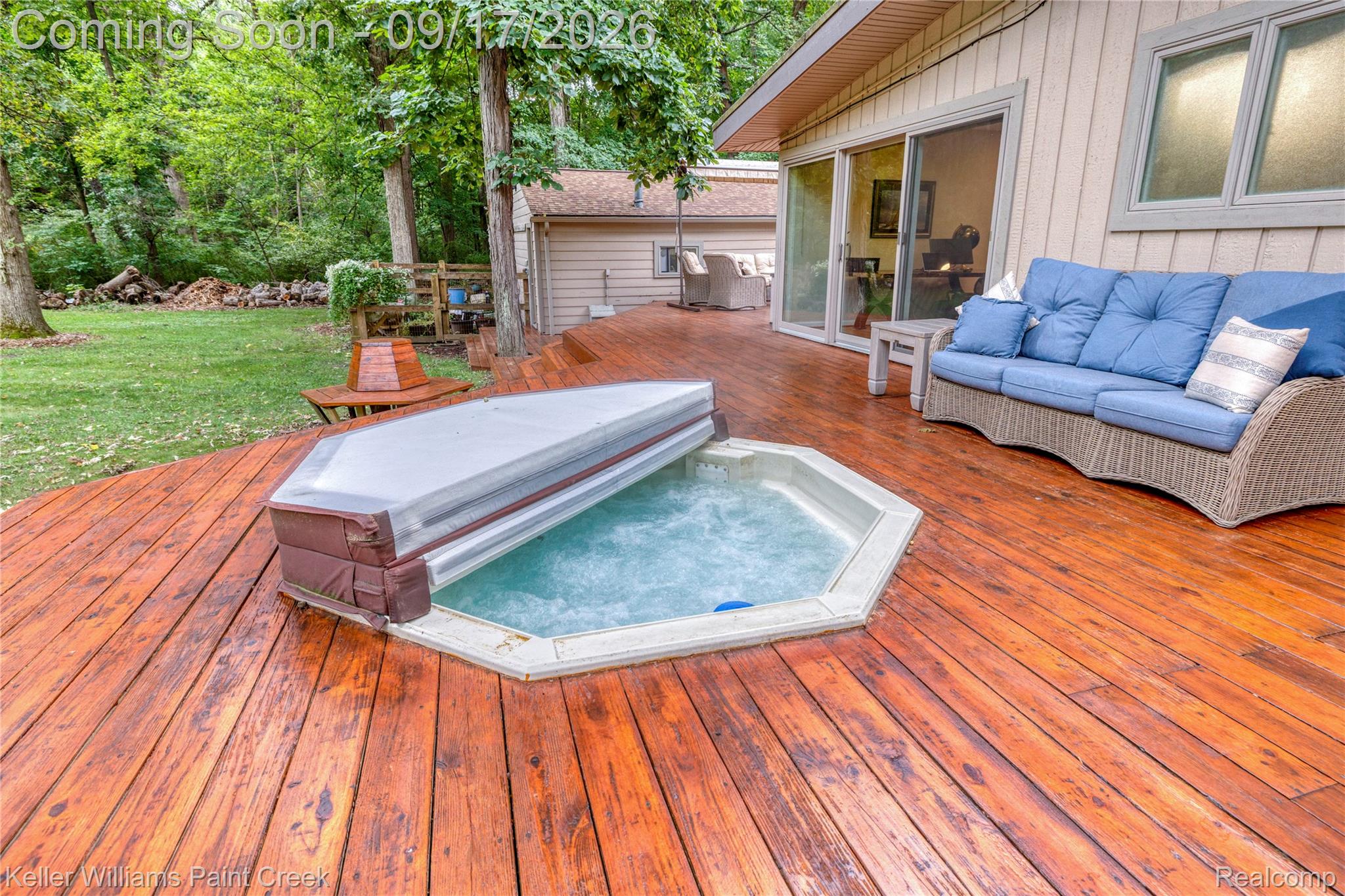 4535 Orion Road Rochester, MI 48306 - Photo 58 of 67 Expansive wood deck with an integrated hot tub and surrounding lush greenery