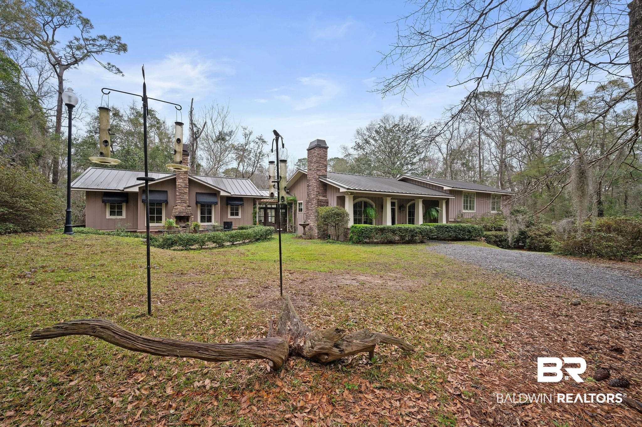 7850 Yorkhaven Road Mobile, AL 36695 - Photo 1 of 57 View of front of home with a standing seam roof, a front yard, a chimney, and metal roof