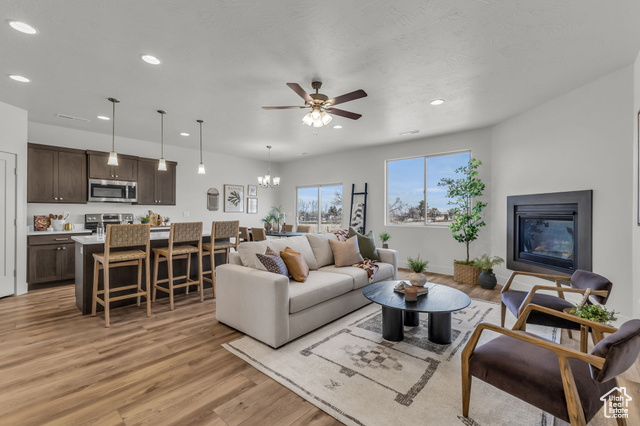 155 East 360th Street East, Unit 10B Fillmore, UT 84631 - Photo 7 of 43 Living room featuring light hardwood / wood-style floors and ceiling fan with notable chandelier