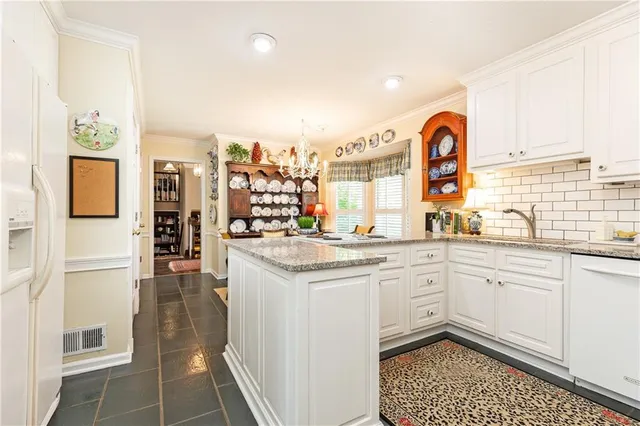 a kitchen with a sink cabinets and window