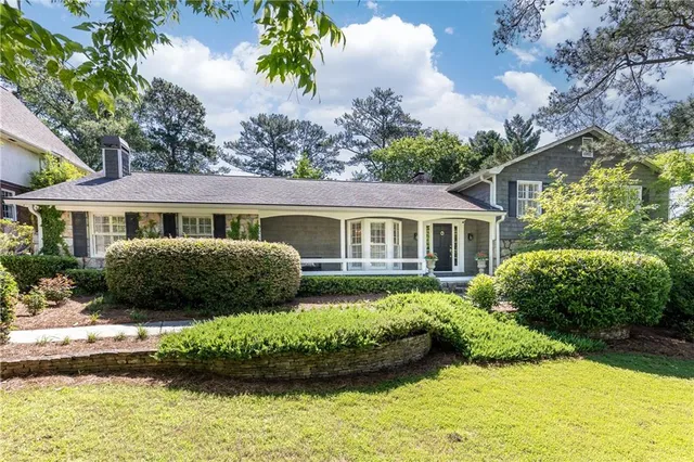 a front view of a house with a garden