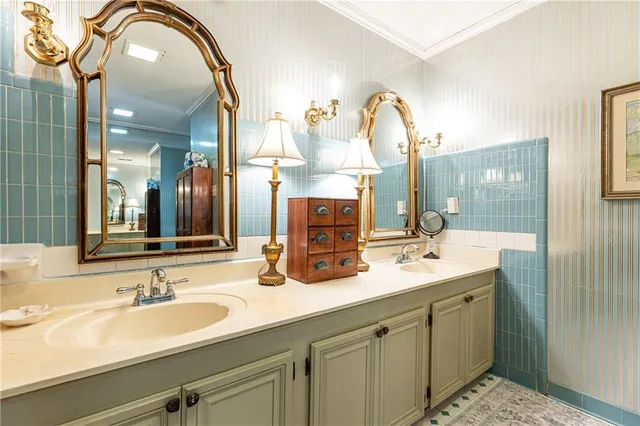 a bathroom with a double vanity sink and a mirror