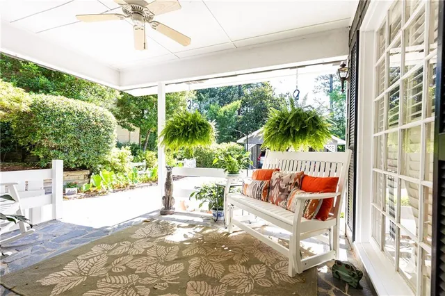 a outdoor space with the couches and dining table with the garden view