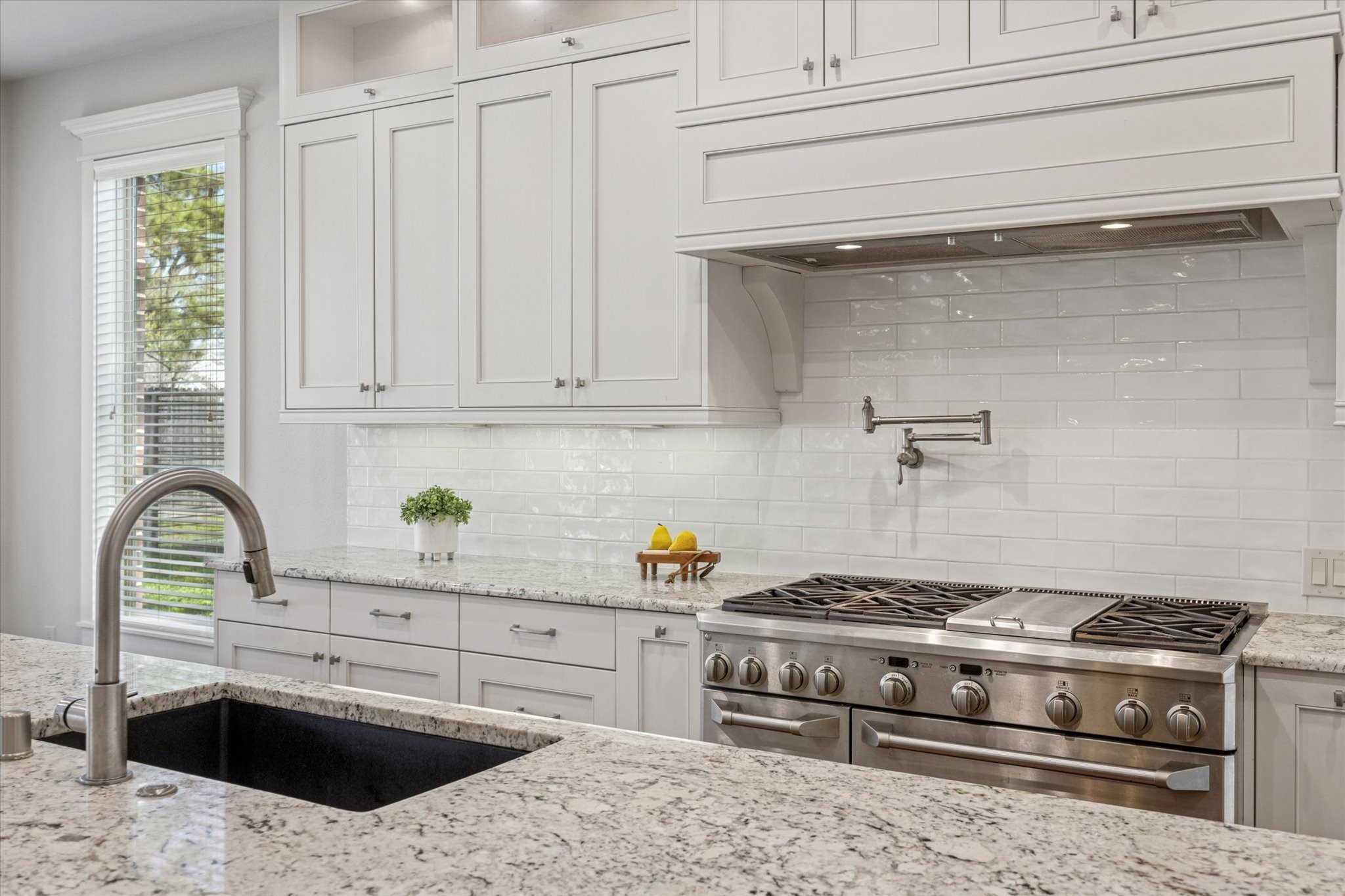 1802 Wakefield Drive Houston, TX 77018 - Photo 16 of 47 Professional-grade range with convenient over-range water filler, perfect for gourmet cooking and effortless meal prep.