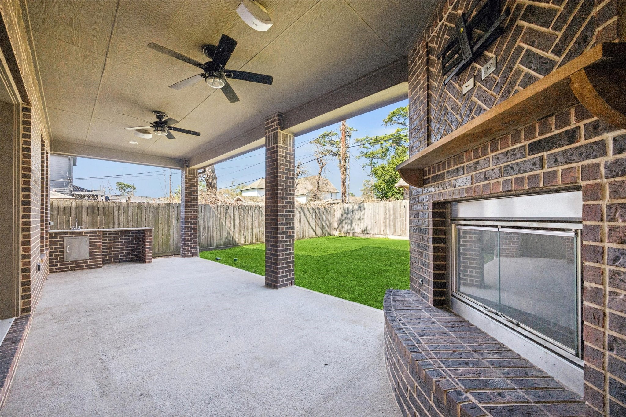 1802 Wakefield Drive Houston, TX 77018 - Photo 37 of 47 Enjoy evenings by the outdoor fireplace with the added convenience of a nearby sink for easy prep and cleanup.