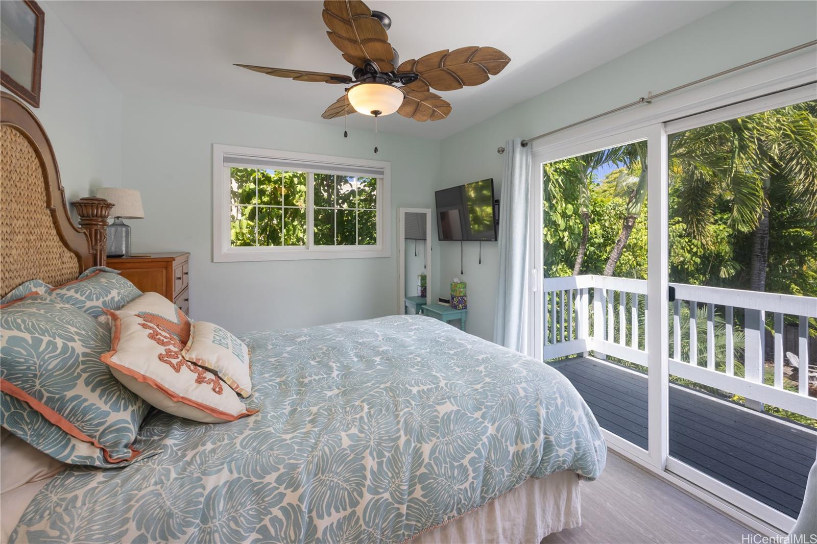 409 Wanaao Road Kailua, HI 96734 - Photo 21 of 25 a bedroom with a bed and a window