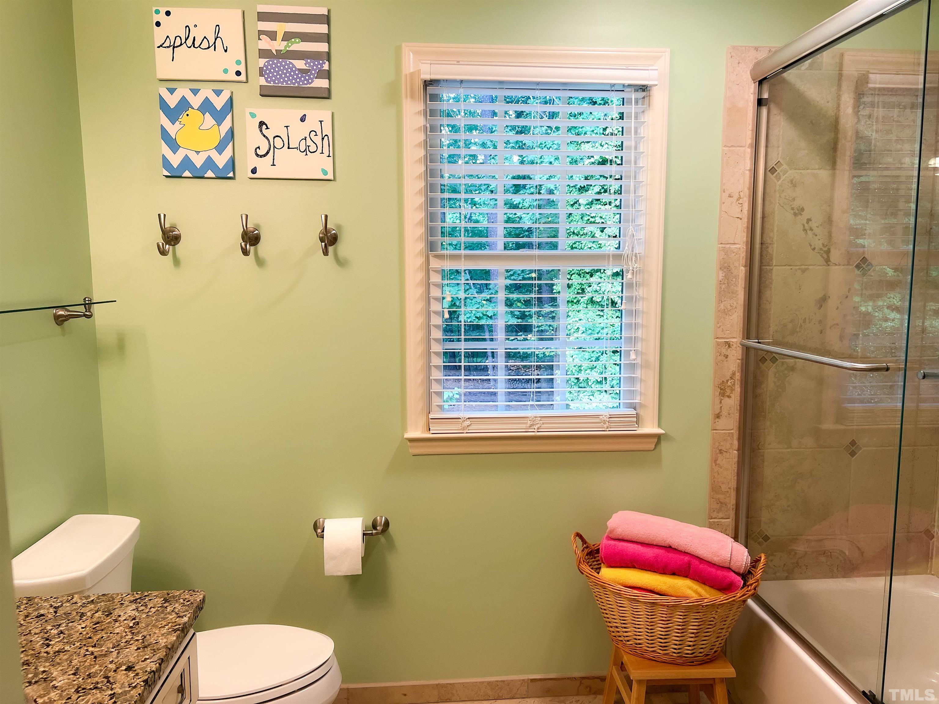 8809 Limestone Court Raleigh, NC 27615 - Photo 33 of 38 a bathroom with a toilet and shower