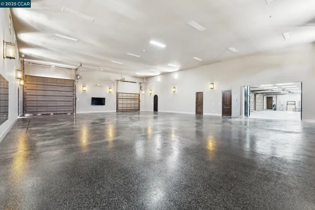 a spacious bathroom with a granite countertop sink mirror and shower