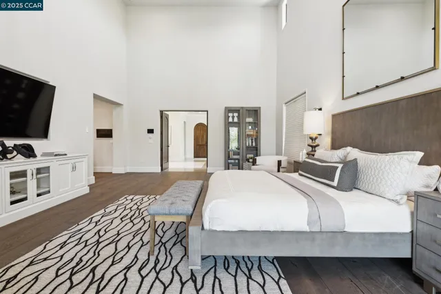 a view of a hallway to a livingroom and a chandelier